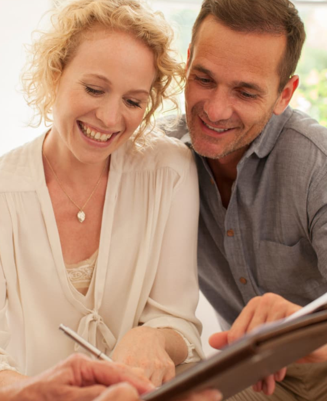Financial Life Insurance Couple Smiling Signing Document